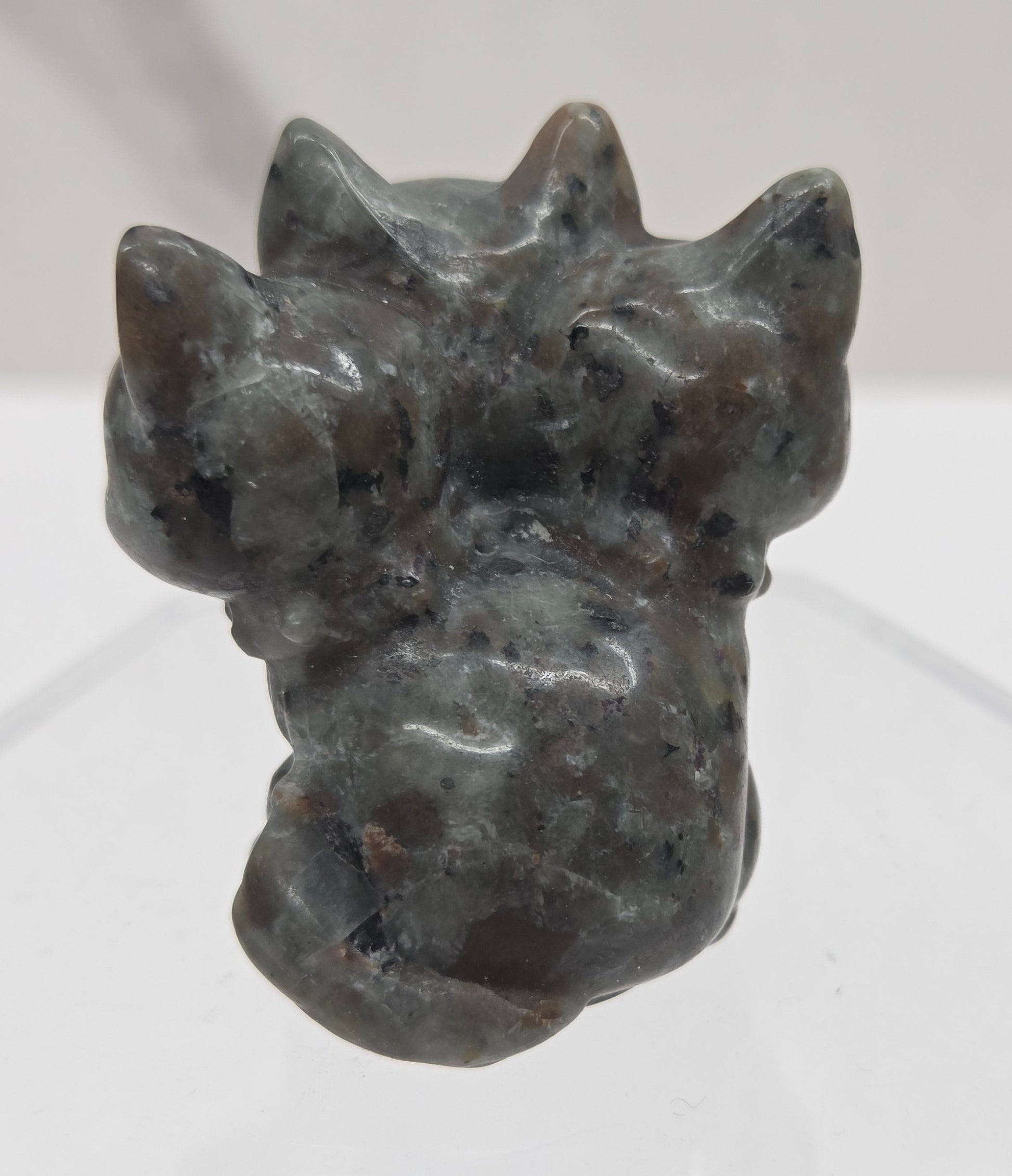 Yooperlite small crystal mythological cerberus animal figurines on a white surface