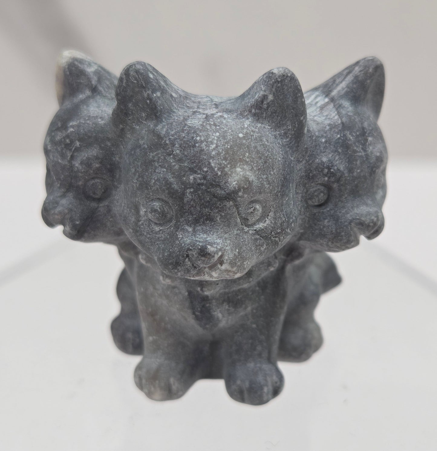 Jasper small crystal mythological cerberus animal figurines on a white surface