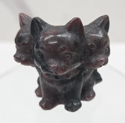 Garnet small crystal mythological cerberus animal figurines on a white surface