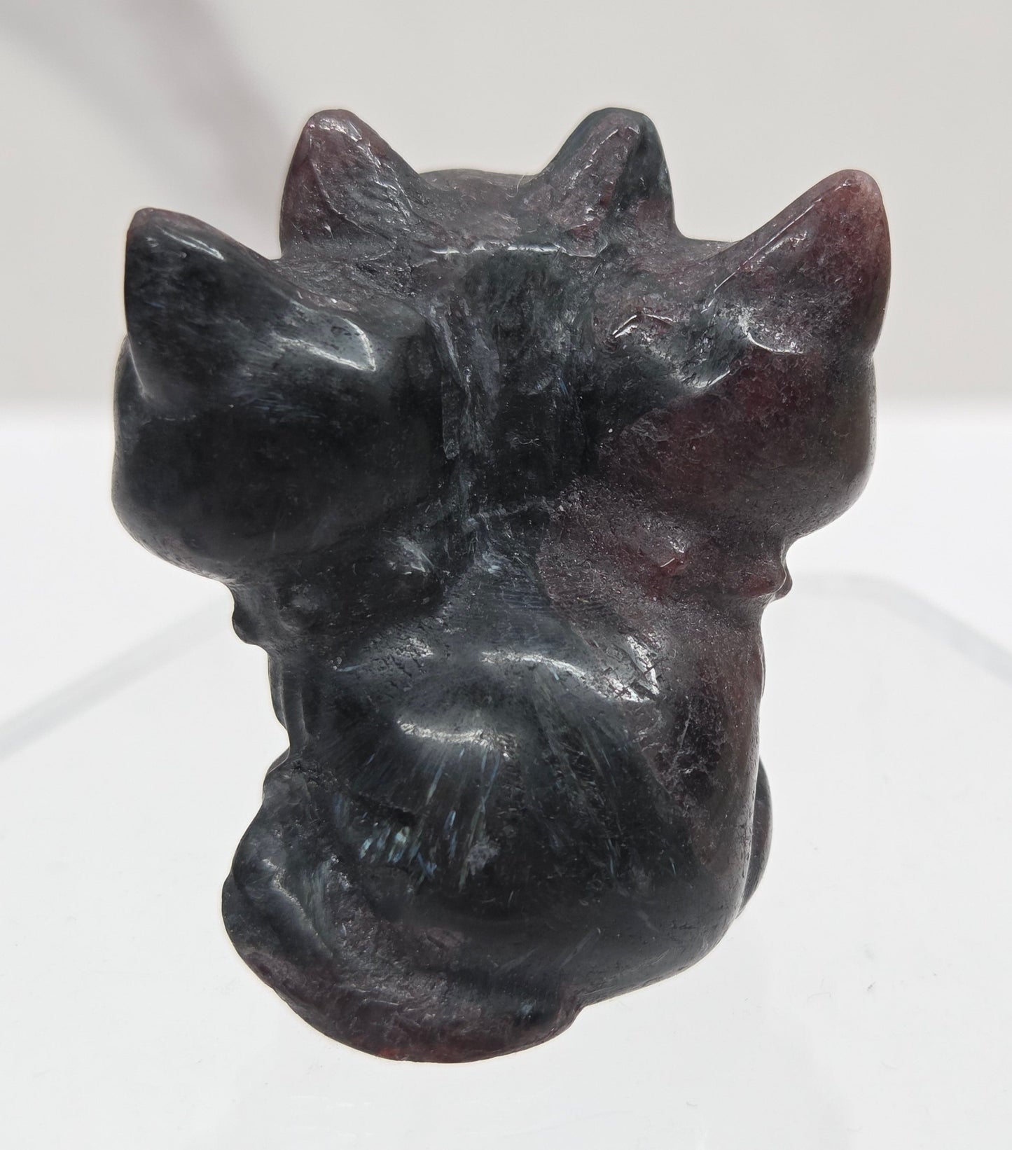 Garnet small crystal mythological cerberus animal figurines on a white surface