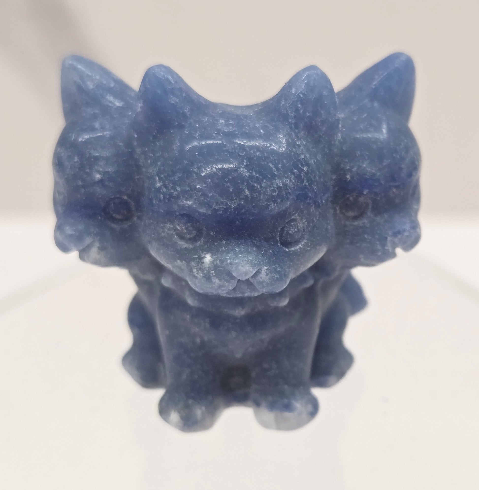 Blue Aventurine small crystal mythological cerberus animal figurines on a white surface