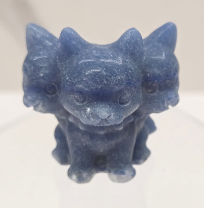 Blue Aventurine small crystal mythological cerberus animal figurines on a white surface