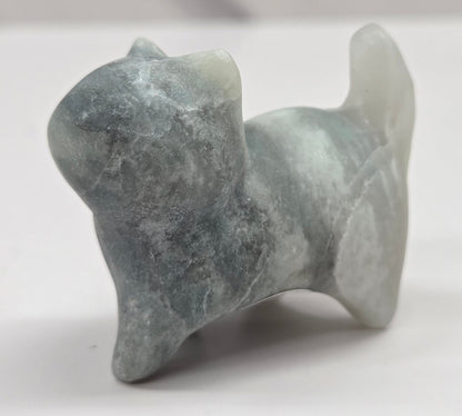 Small stone blue calcite sculpture of a cat on a white background