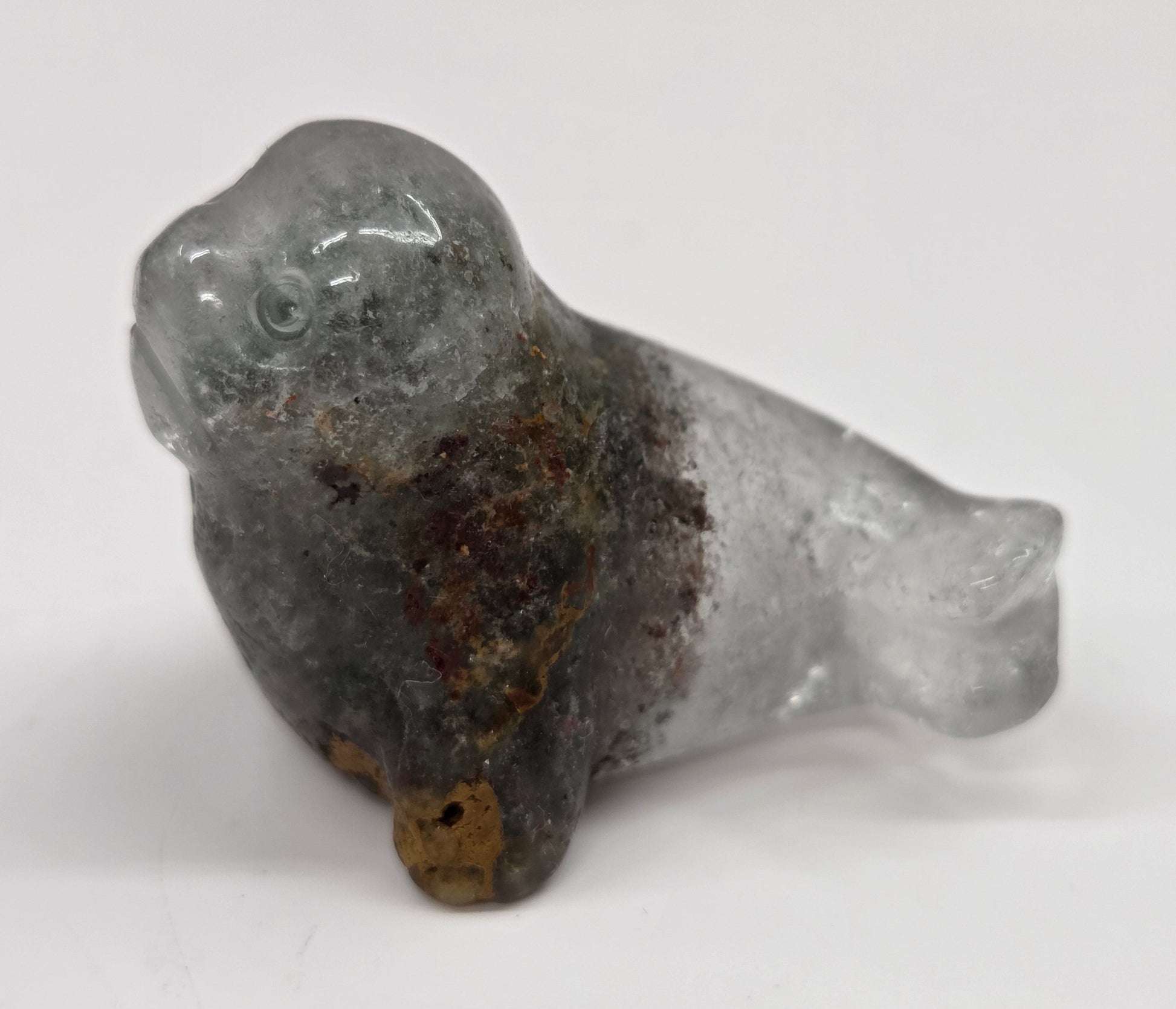 Seal shaped garden quartz crystal carving on a white background