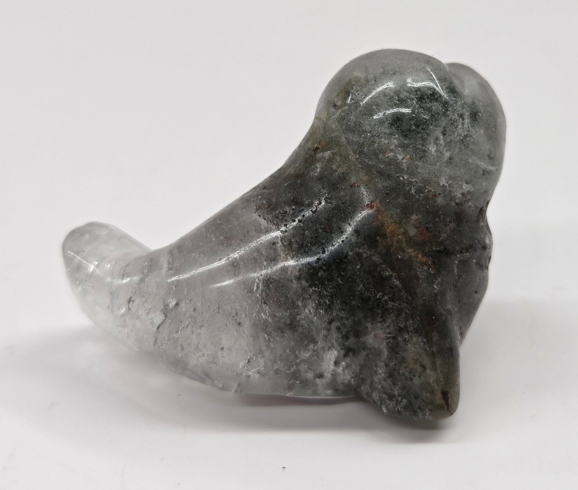 Seal shaped garden quartz crystal carving on a white background