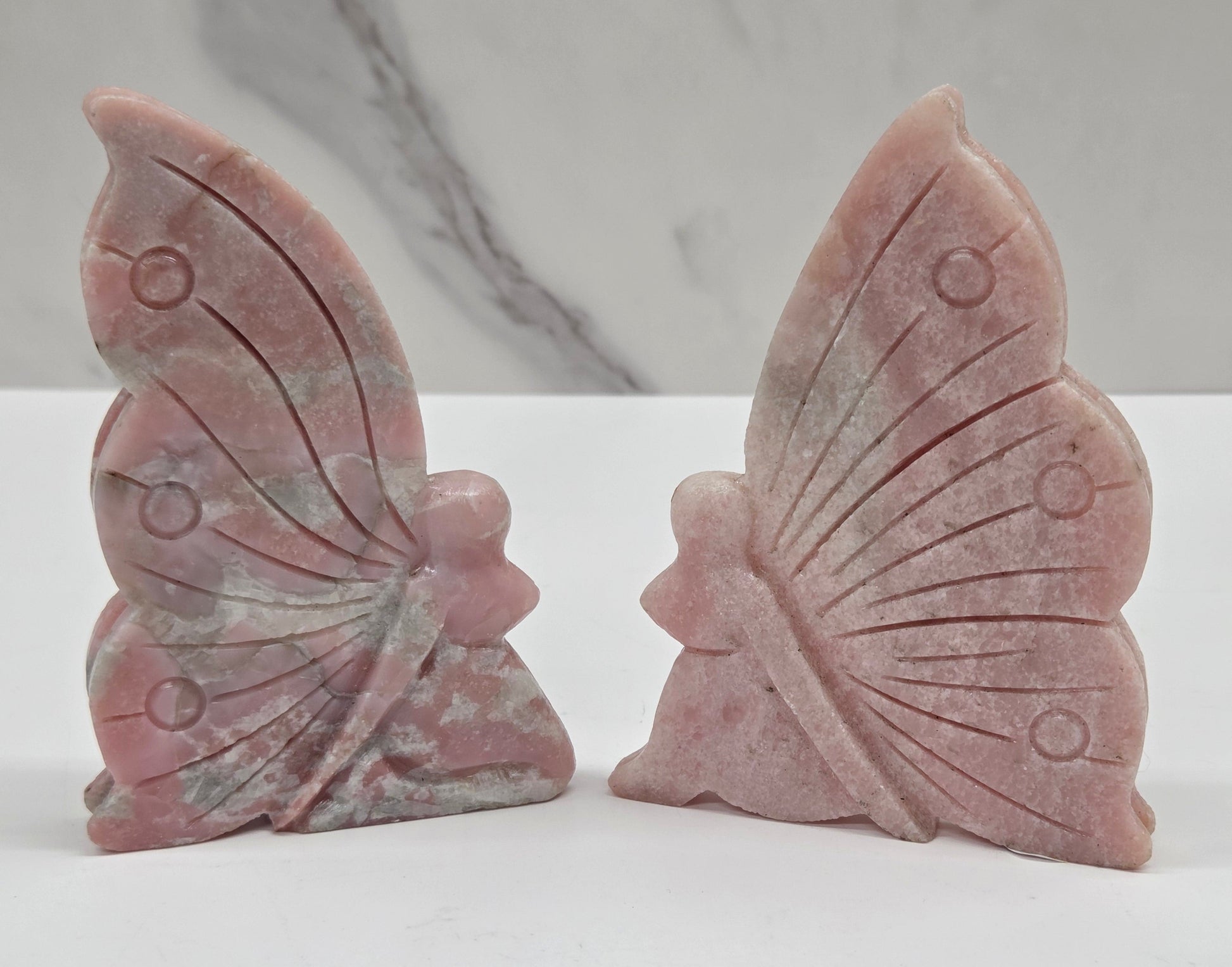 Pink Opal fairy carvings on a white background