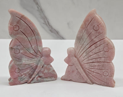 Pink Opal fairy carvings on a white background