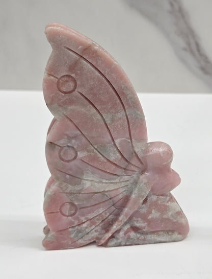 Pink Opal fairy carving on a white background