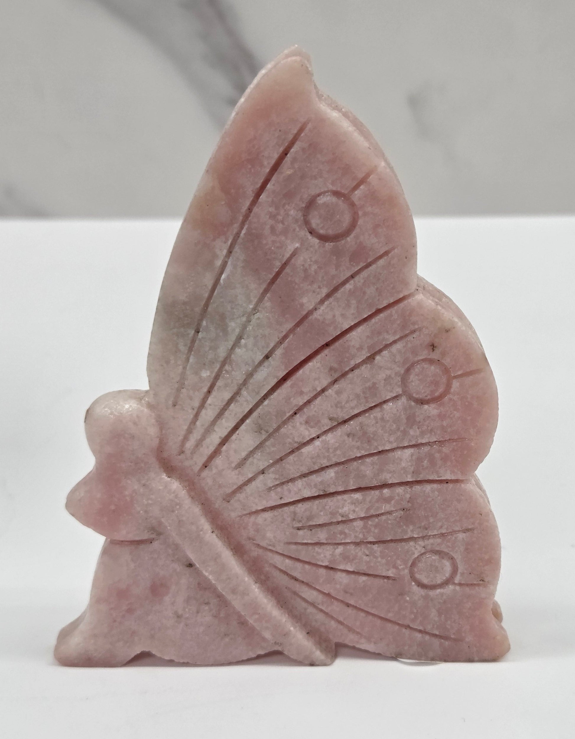 Pink Opal fairy carvings on a white background