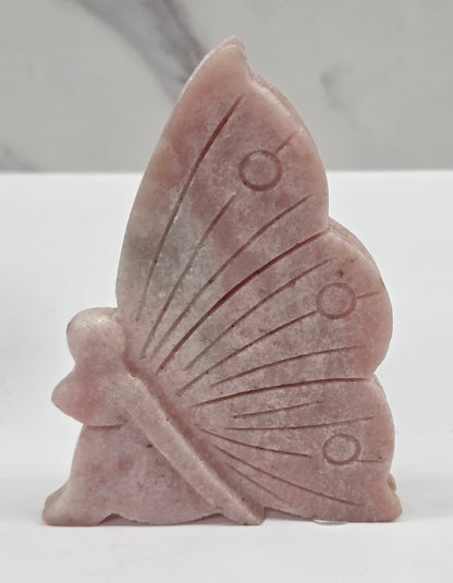 Pink Opal fairy carvings on a white background