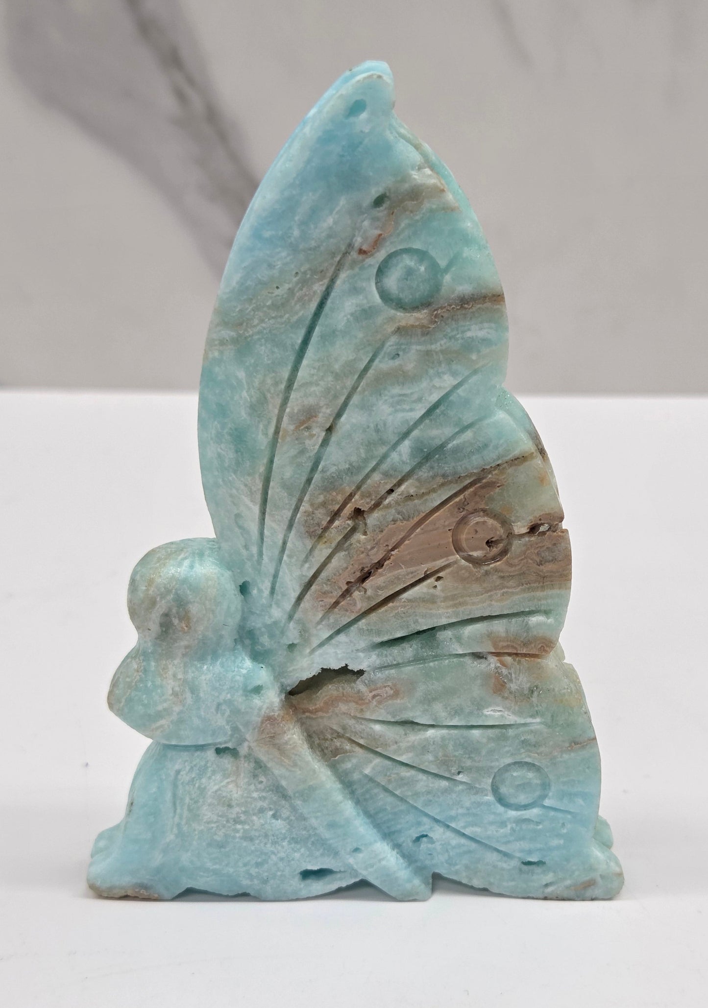 Blue Hemimorphite fairy carvings on a white background