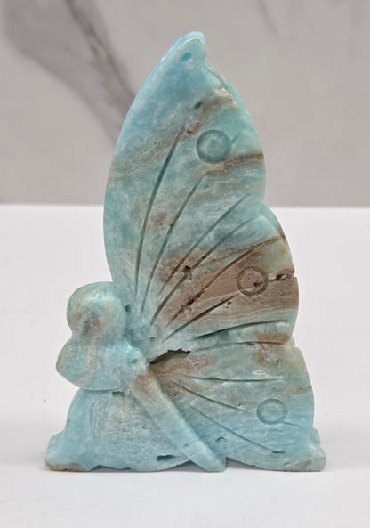 Blue Hemimorphite fairy carvings on a white background