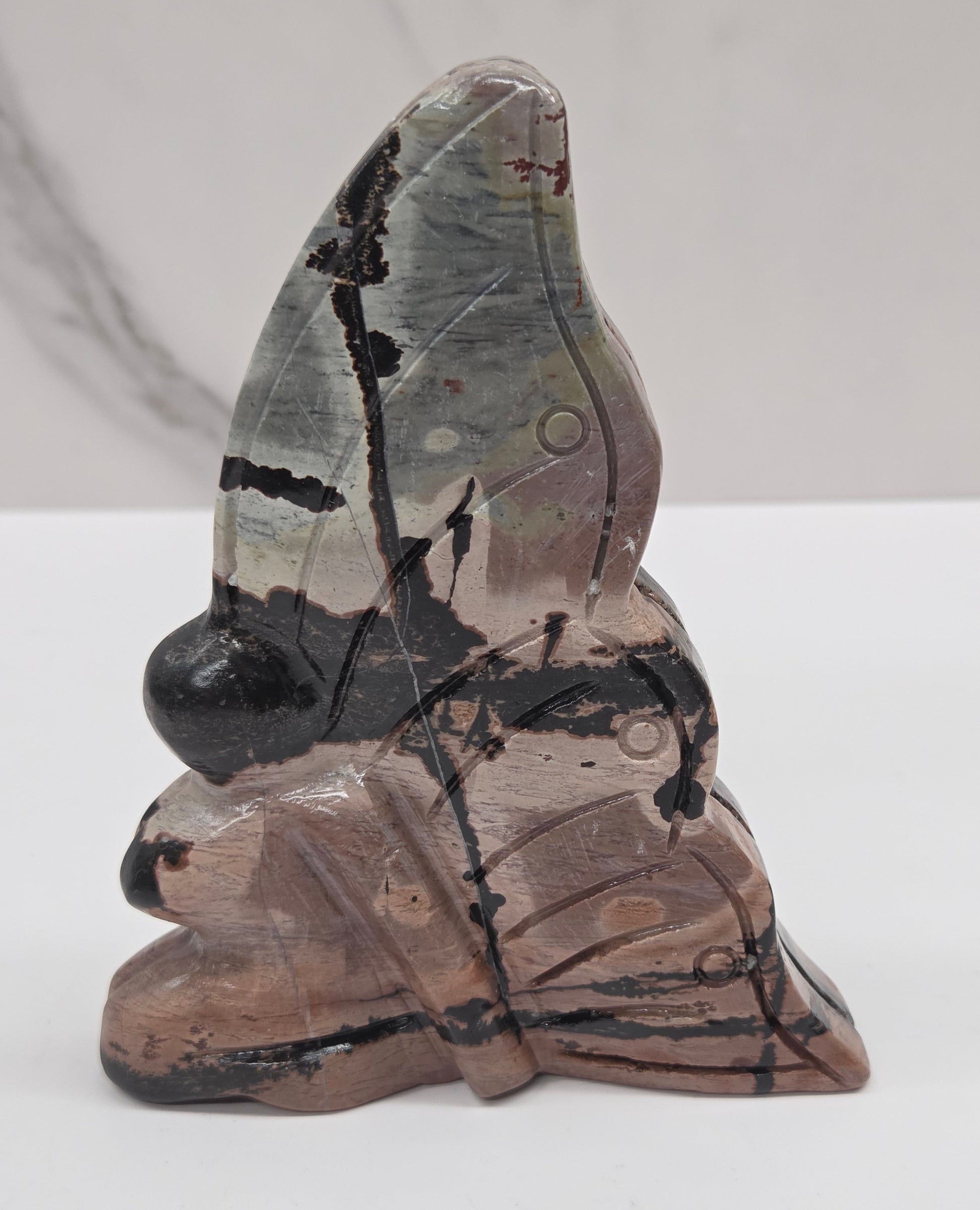 Picture Jasper fairy carving with a variety of patterns and colors on a white background
