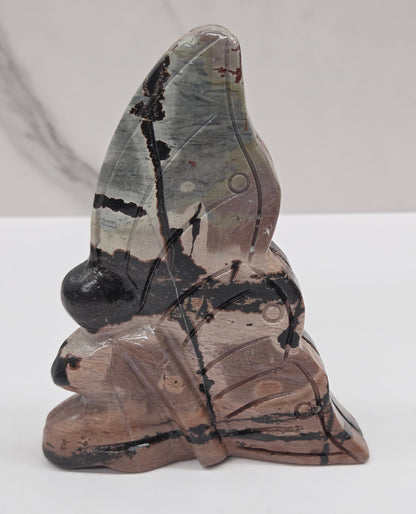 Picture Jasper fairy carving with a variety of patterns and colors on a white background