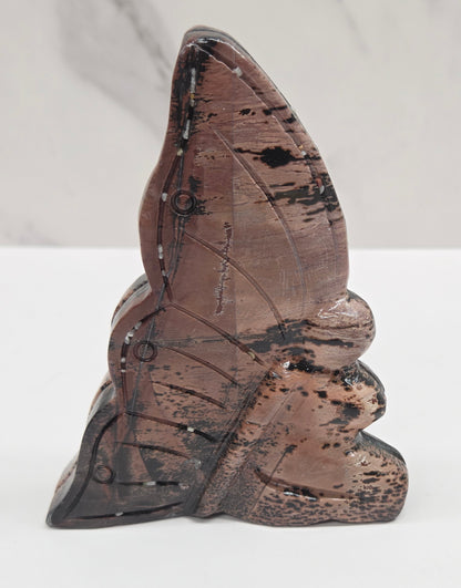 Picture Jasper fairy carving with a variety of patterns and colors on a white background