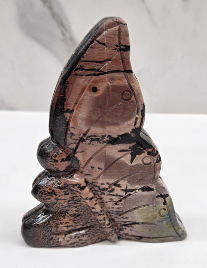 Picture Jasper fairy carving with a variety of patterns and colors on a white background