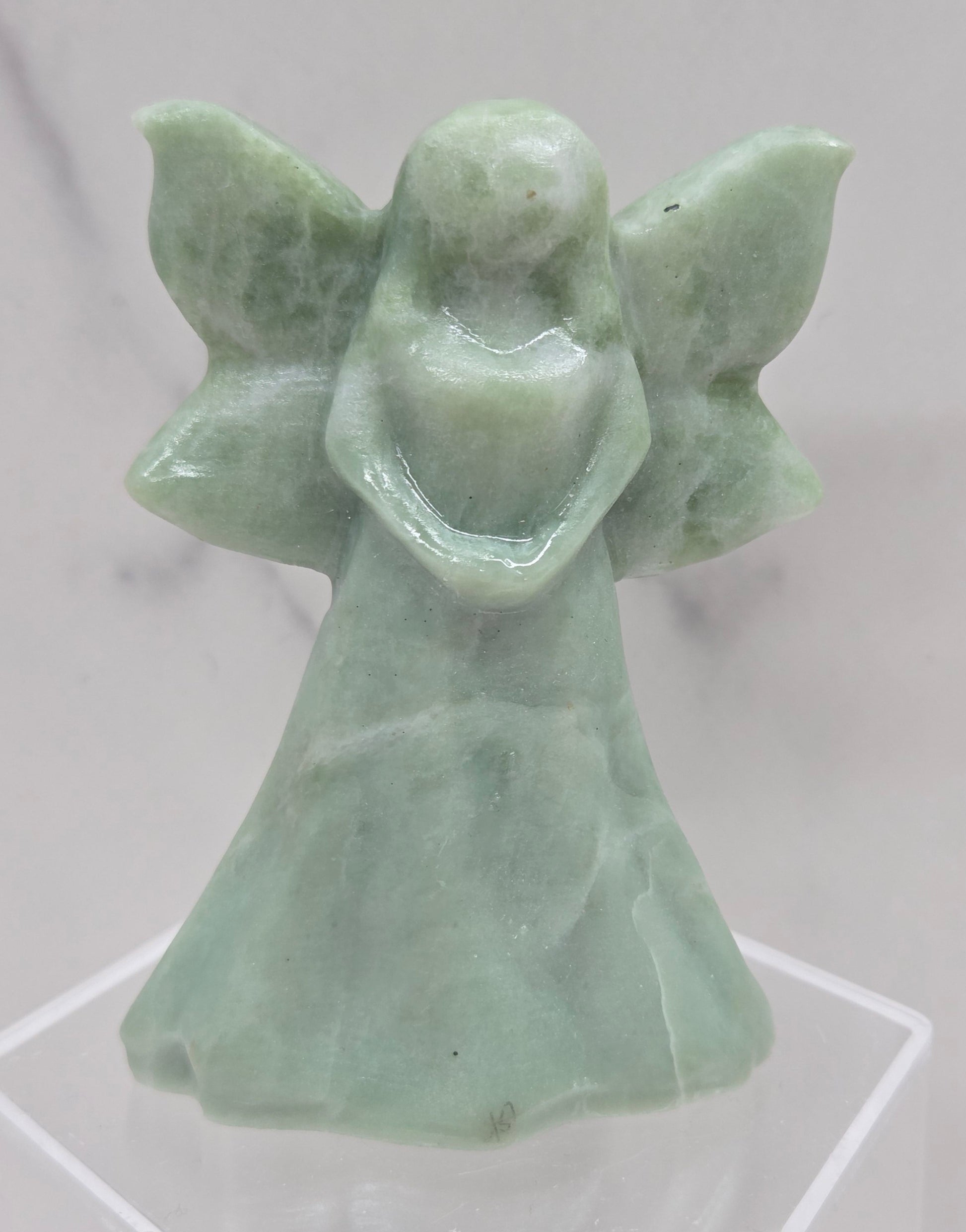 Green jade fairy figurine on a white background