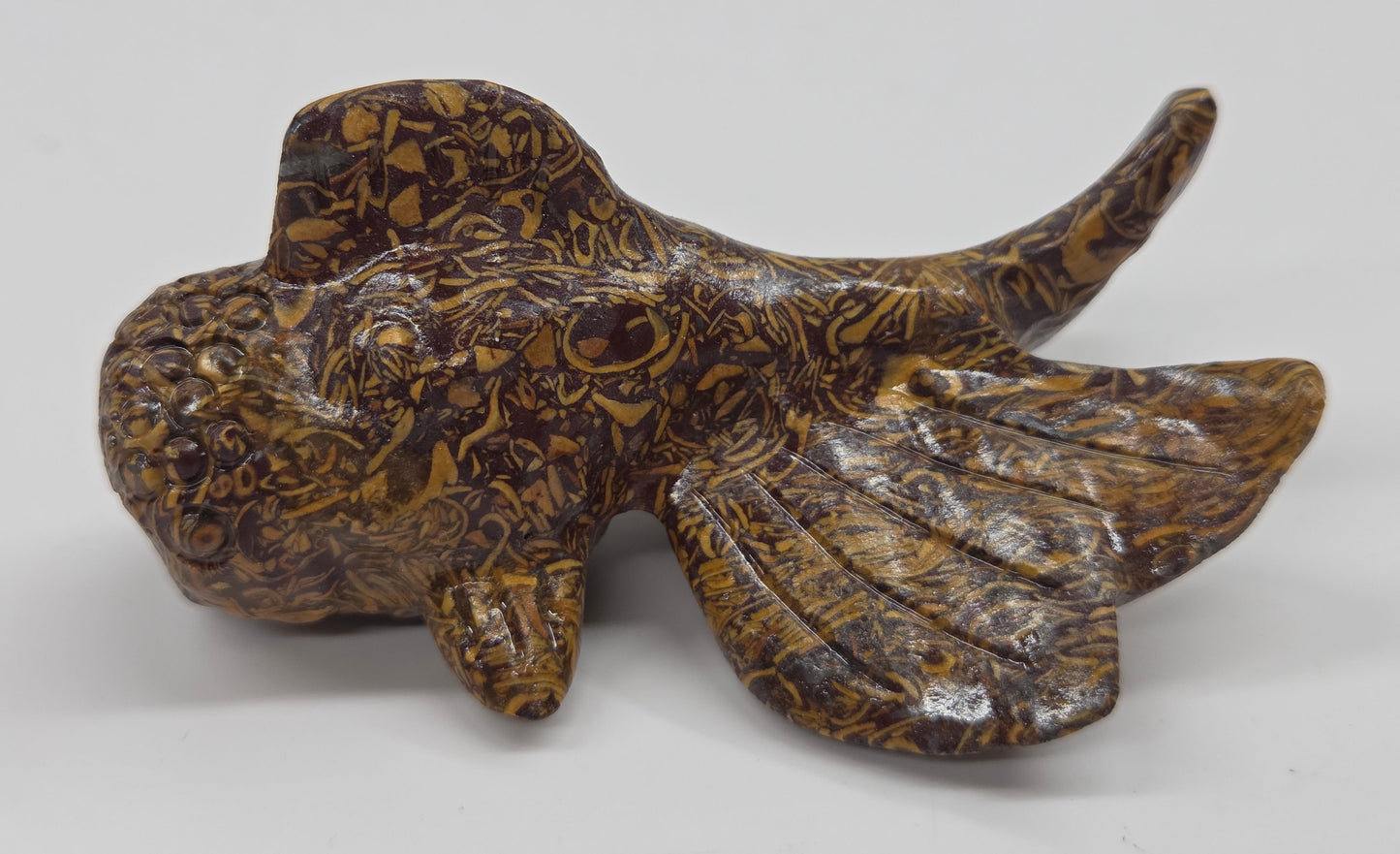 Colorful calligraphy jasper fish figurine on a white background