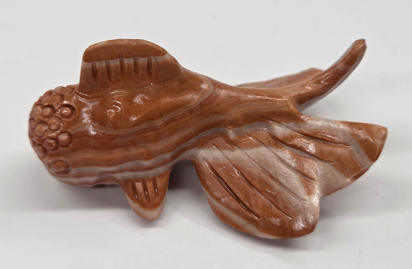 Red Jasper fish figurine on a white background