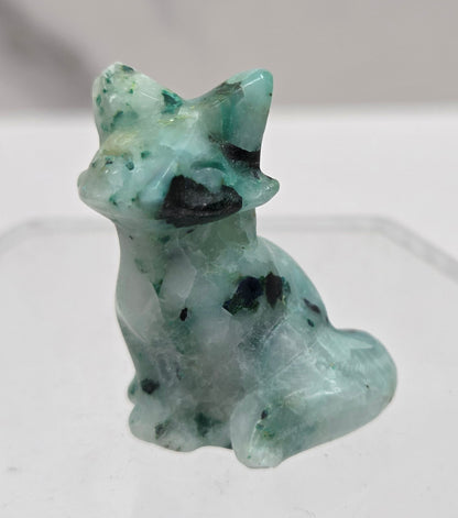Small white and greenish-blue fox carving on a  white background
