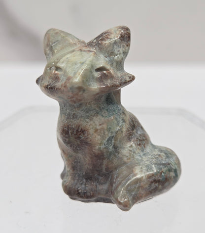 Small fox carving with multiple colors  on a  white background
