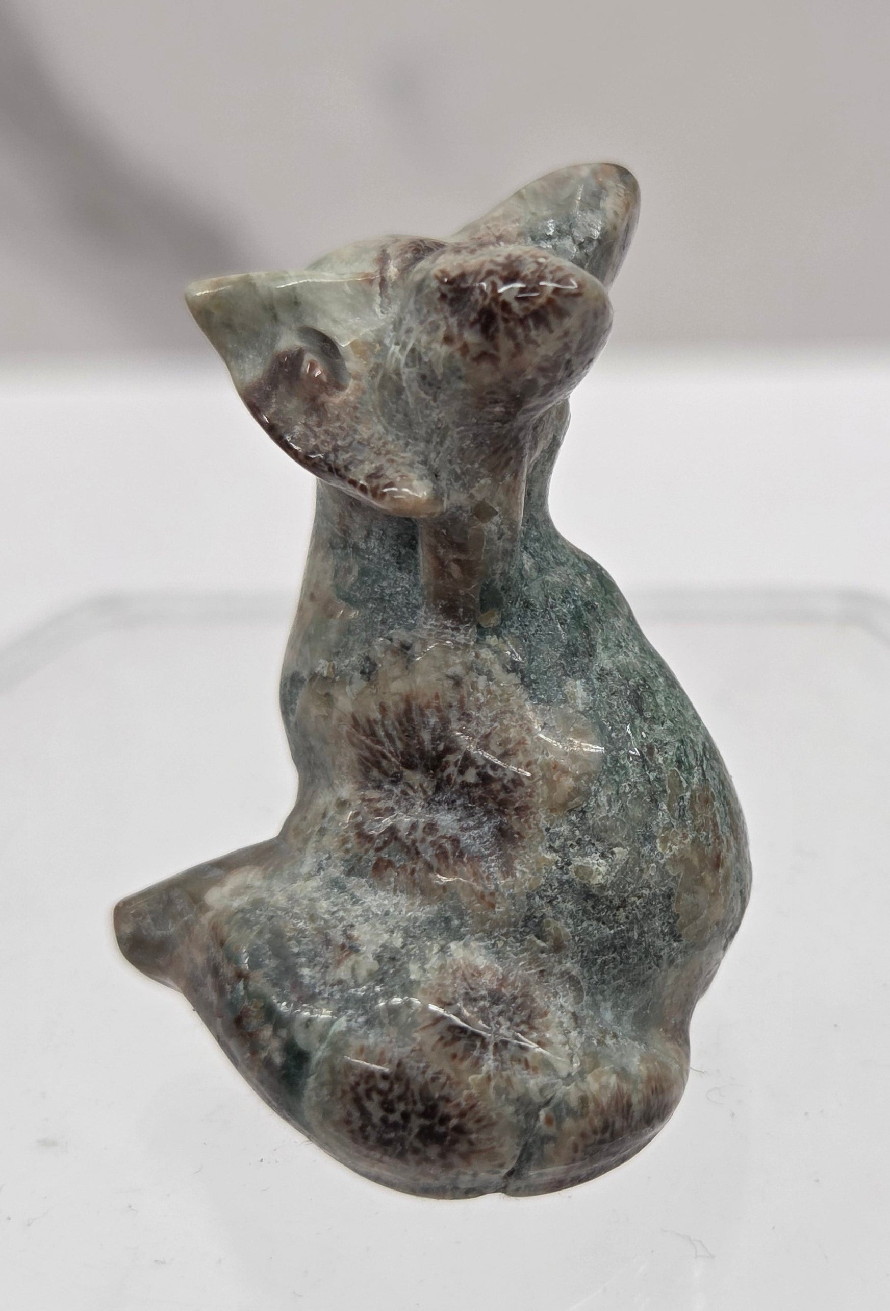 Small fox carving with multiple colors  on a  white background