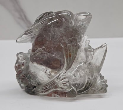 Dolphin in a wave shaped garden quartz crystal carving on a white background