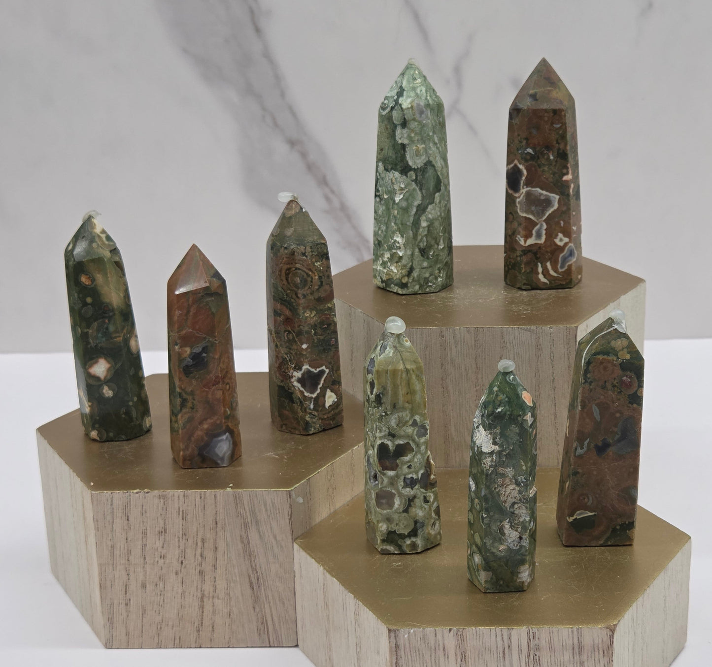 Set of crystal points on a wooden stand against a marble background