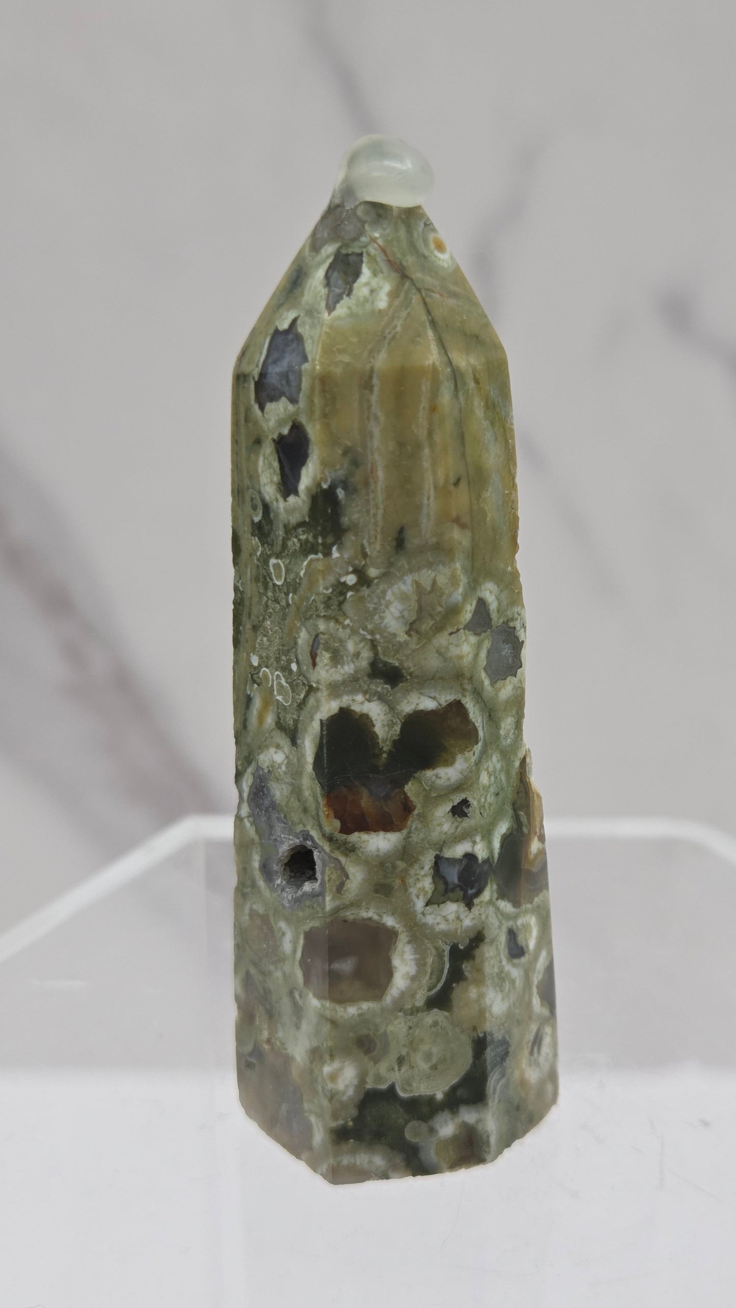 Decorative rainforest jasper tower with multiple colors and patterns on a white background