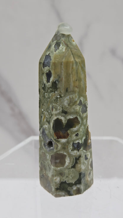 Decorative rainforest jasper tower with multiple colors and patterns on a white background