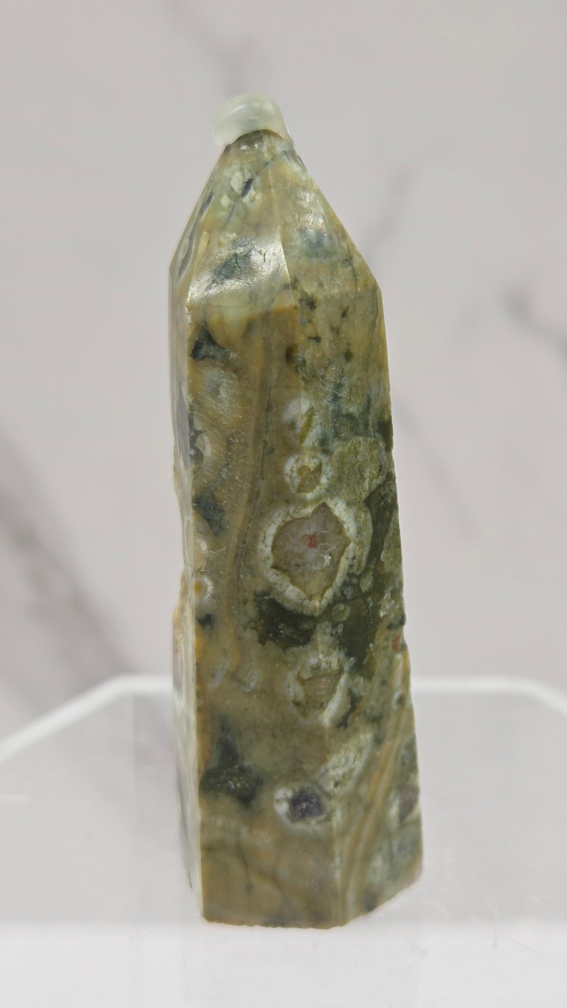 Decorative rainforest jasper tower with multiple colors and patterns on a white background
