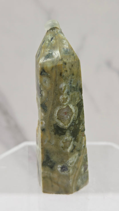 Decorative rainforest jasper tower with multiple colors and patterns on a white background