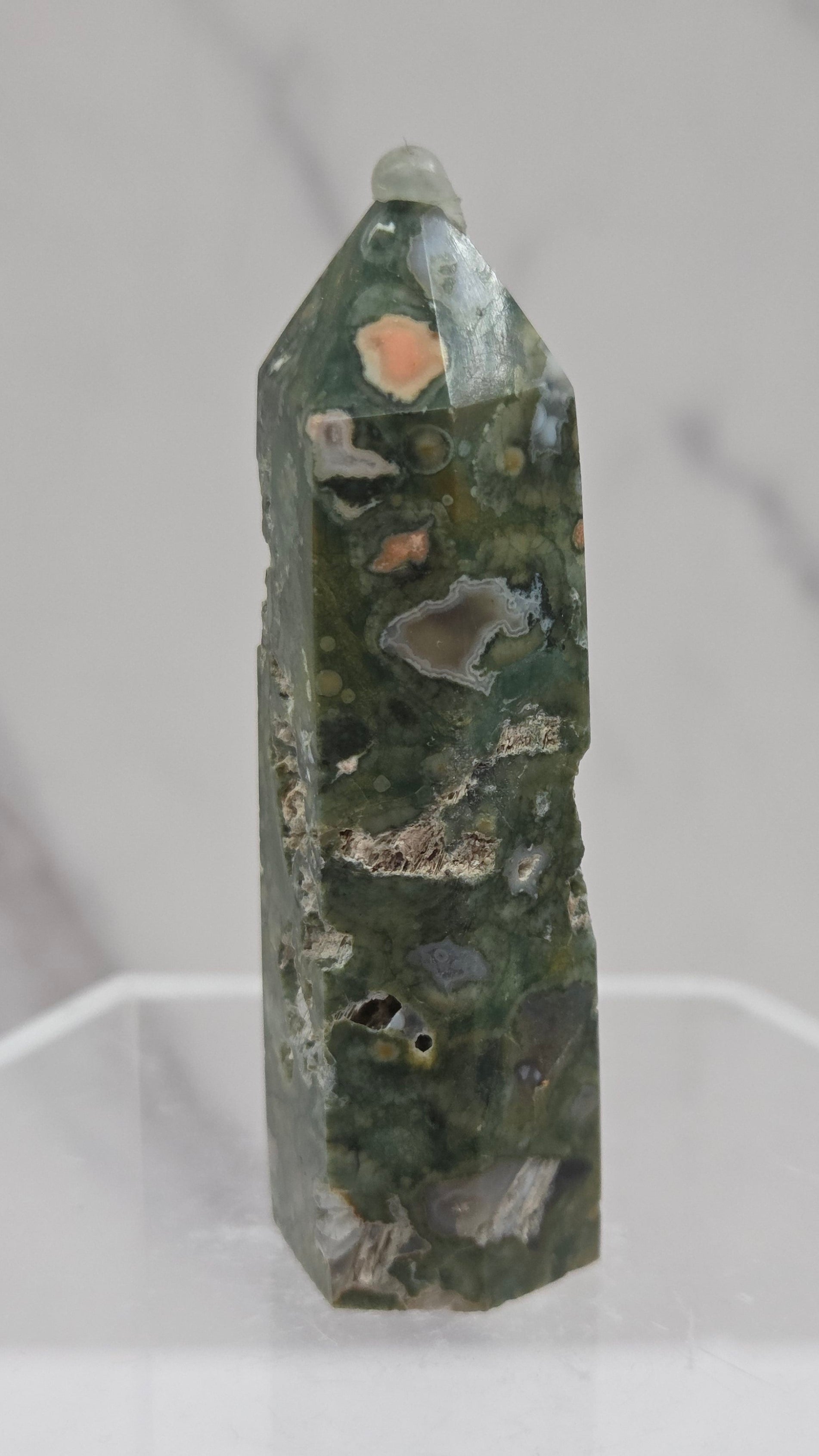 Decorative rainforest jasper tower with multiple colors and patterns on a white background