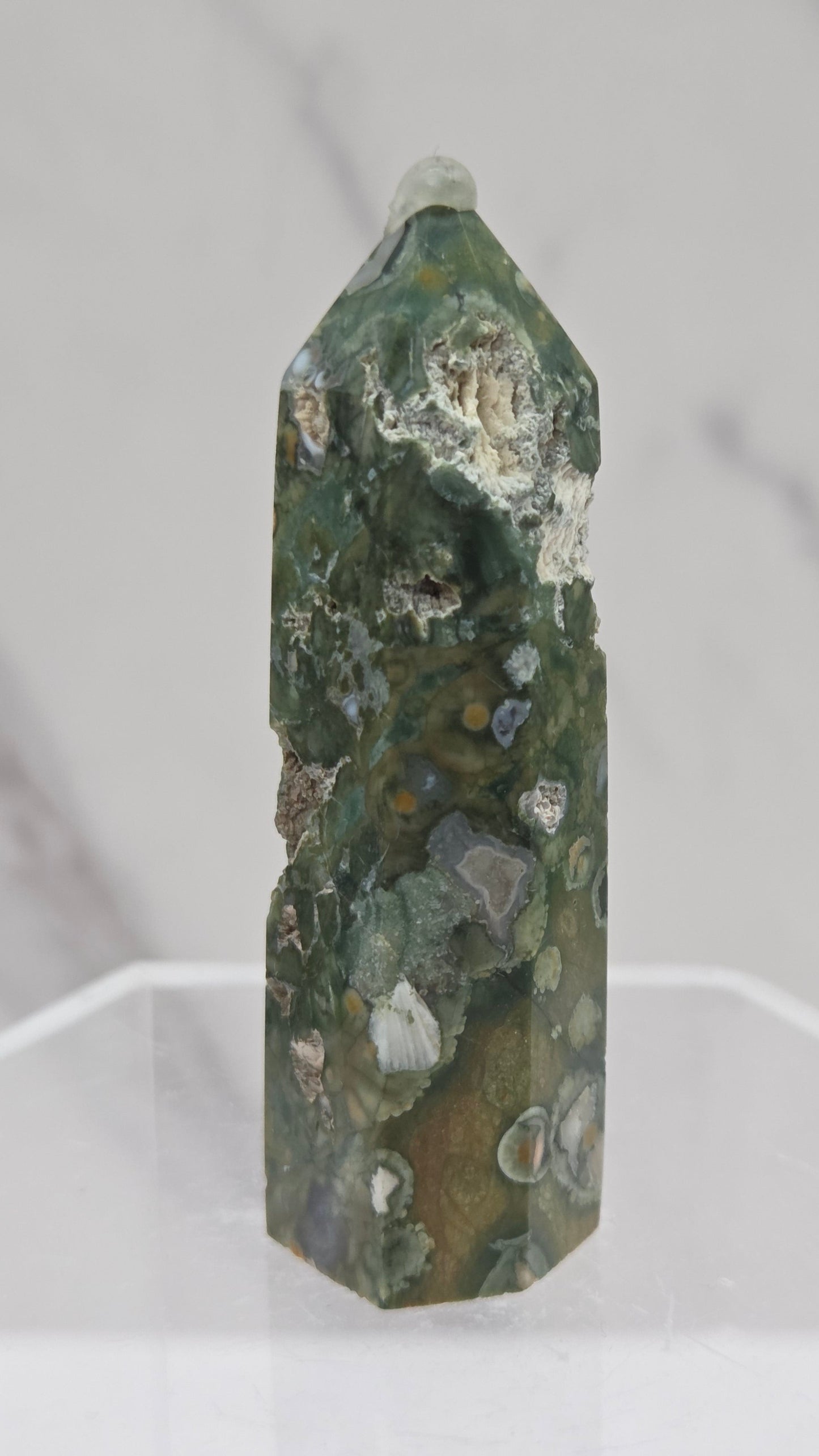 Decorative rainforest jasper tower with multiple colors and patterns on a white background