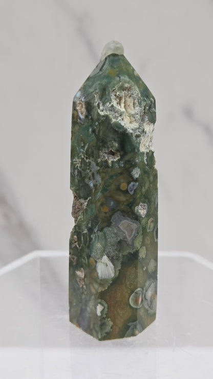 Decorative rainforest jasper tower with multiple colors and patterns on a white background