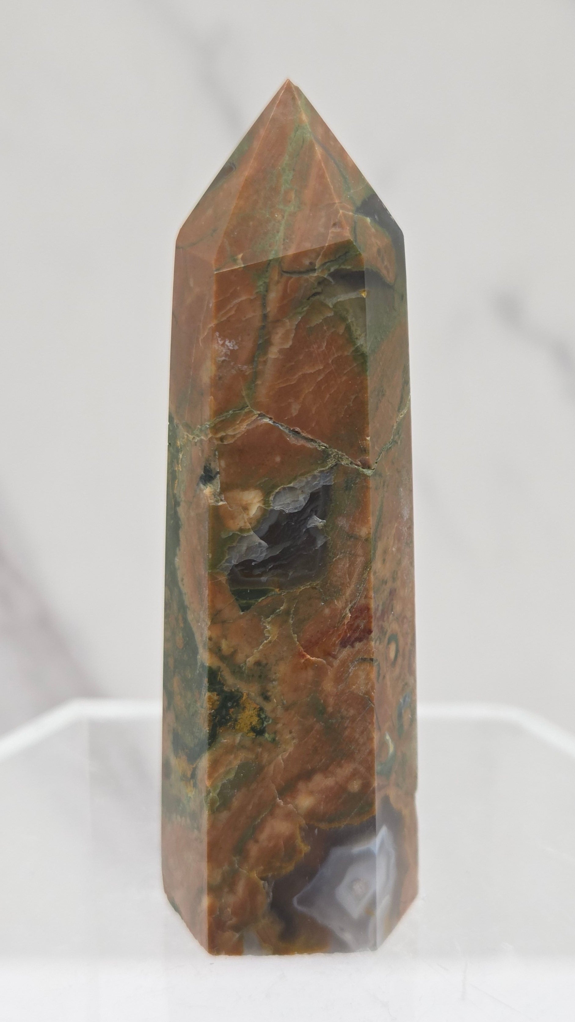 Decorative rainforest jasper tower with multiple colors and patterns on a white background