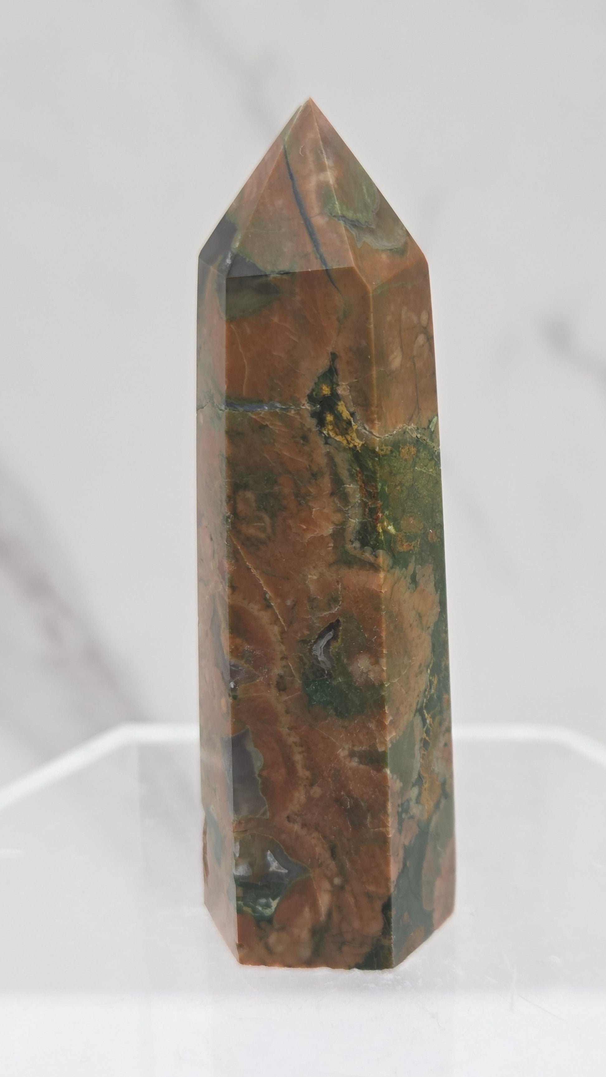 Decorative rainforest jasper tower with multiple colors and patterns on a white background