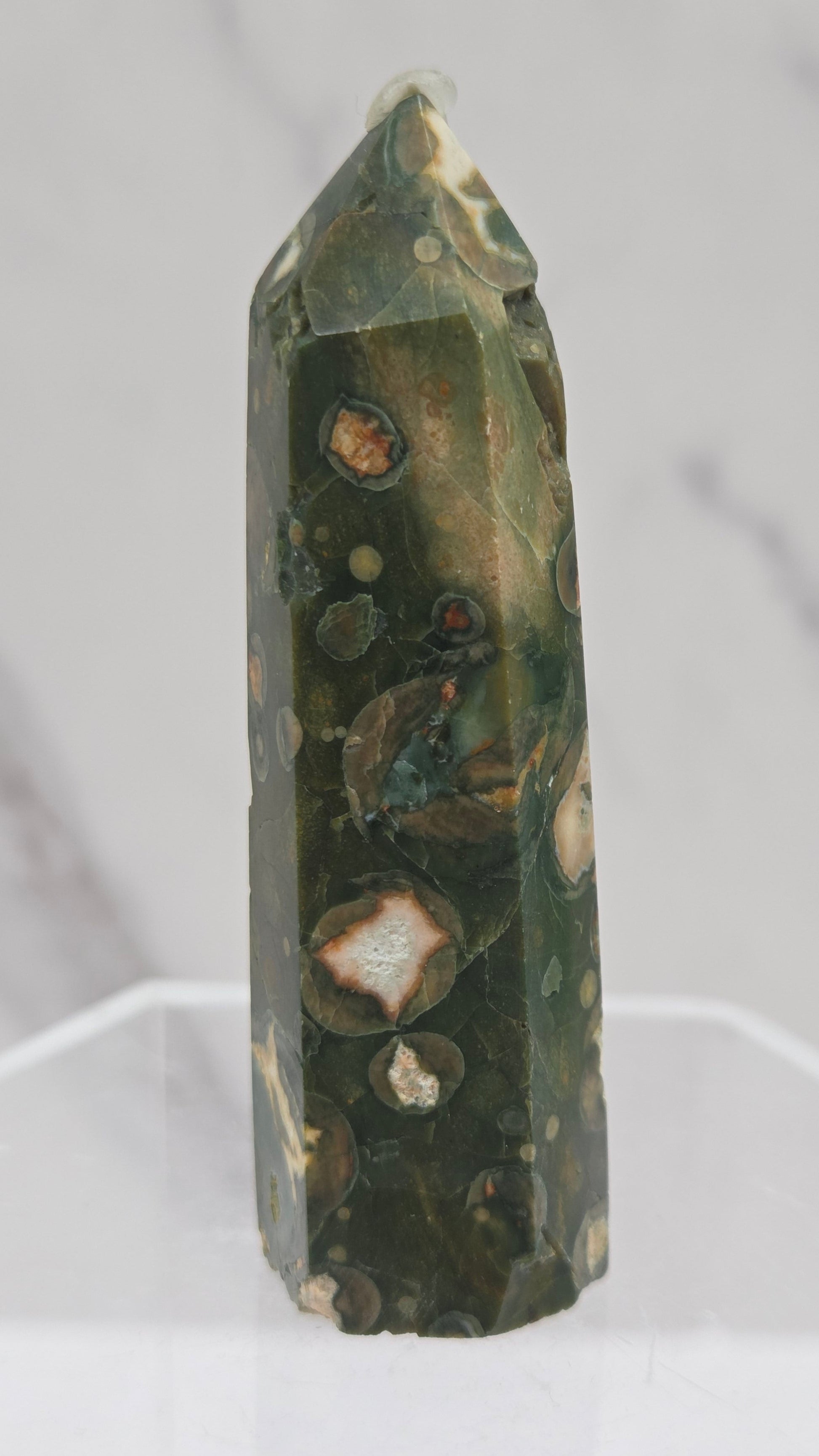Decorative rainforest jasper tower with multiple colors and patterns on a white background