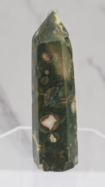 Decorative rainforest jasper tower with multiple colors and patterns on a white background