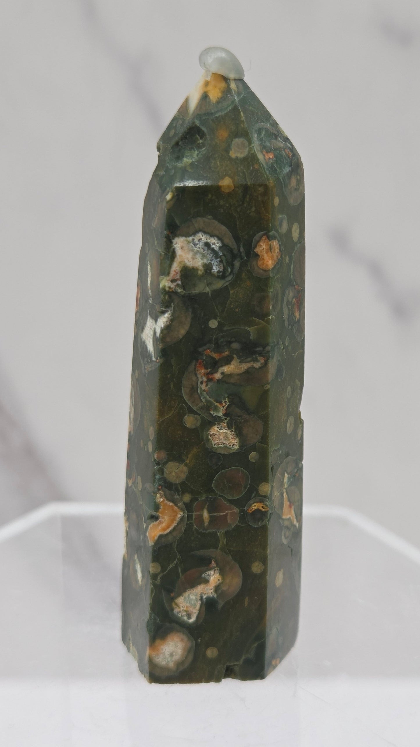 Decorative rainforest jasper tower with multiple colors and patterns on a white background