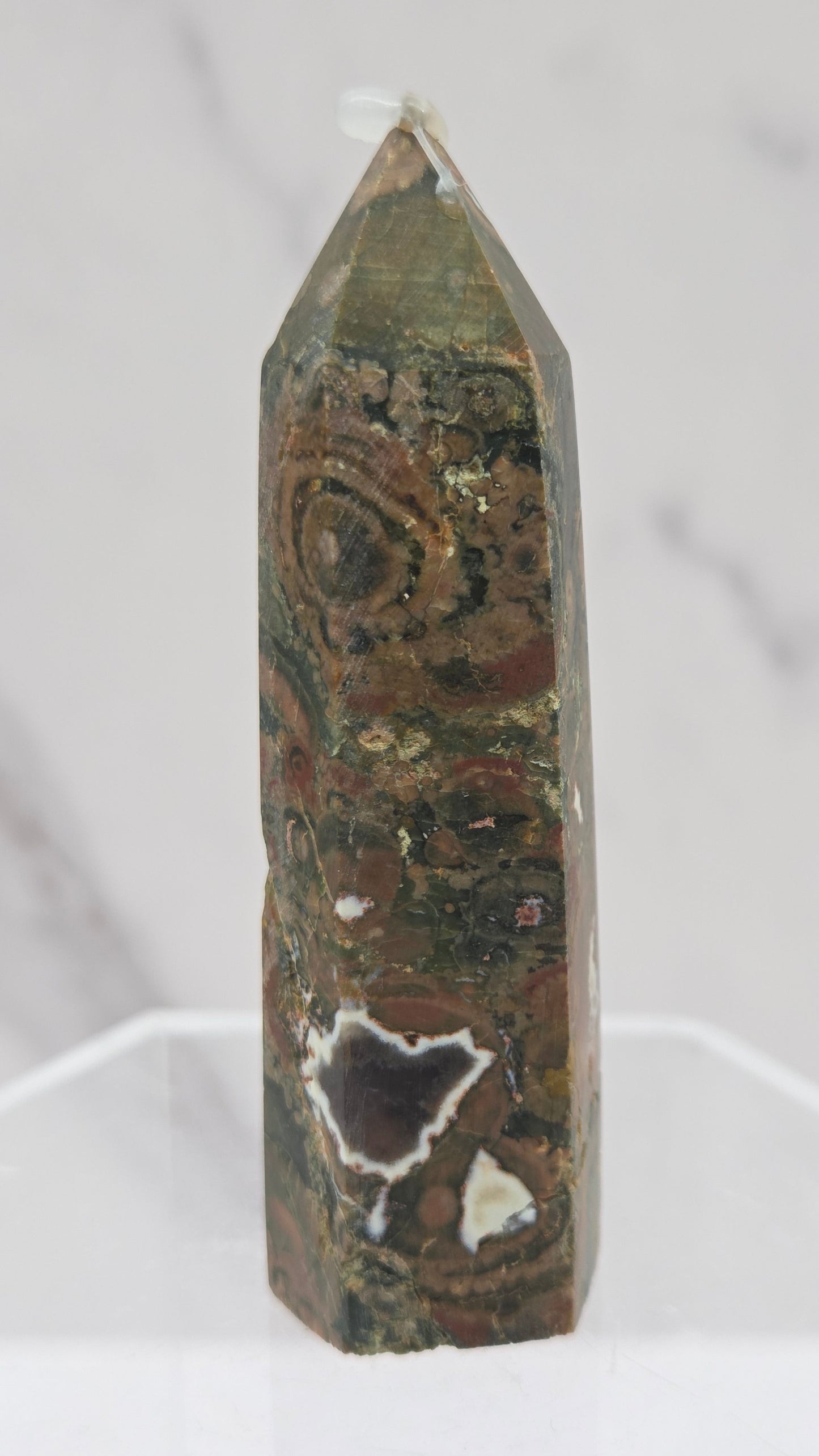 Decorative rainforest jasper tower with multiple colors and patterns on a white background