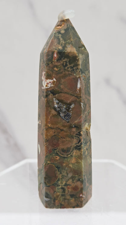 Decorative rainforest jasper tower with multiple colors and patterns on a white background