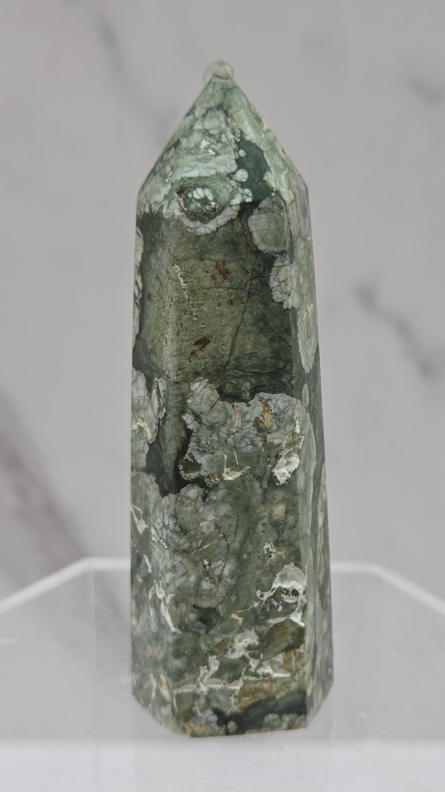 Decorative rainforest jasper tower with multiple colors and patterns on a white background