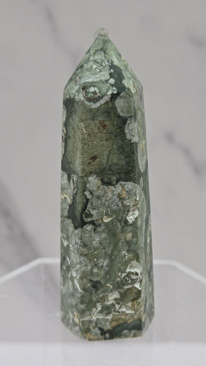 Decorative rainforest jasper tower with multiple colors and patterns on a white background