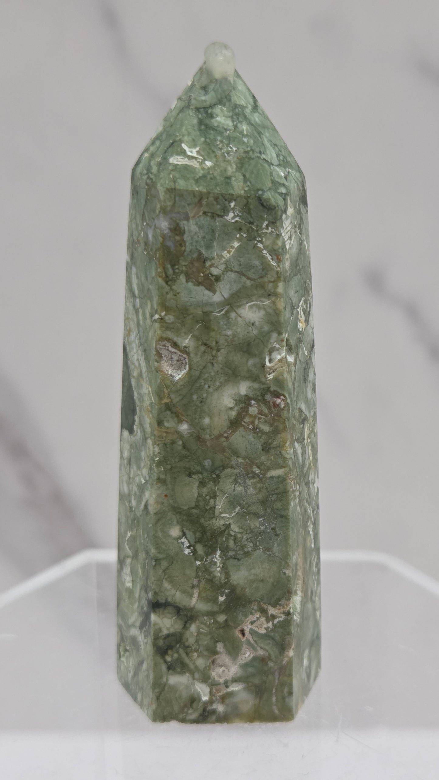 Decorative rainforest jasper tower with multiple colors and patterns on a white background