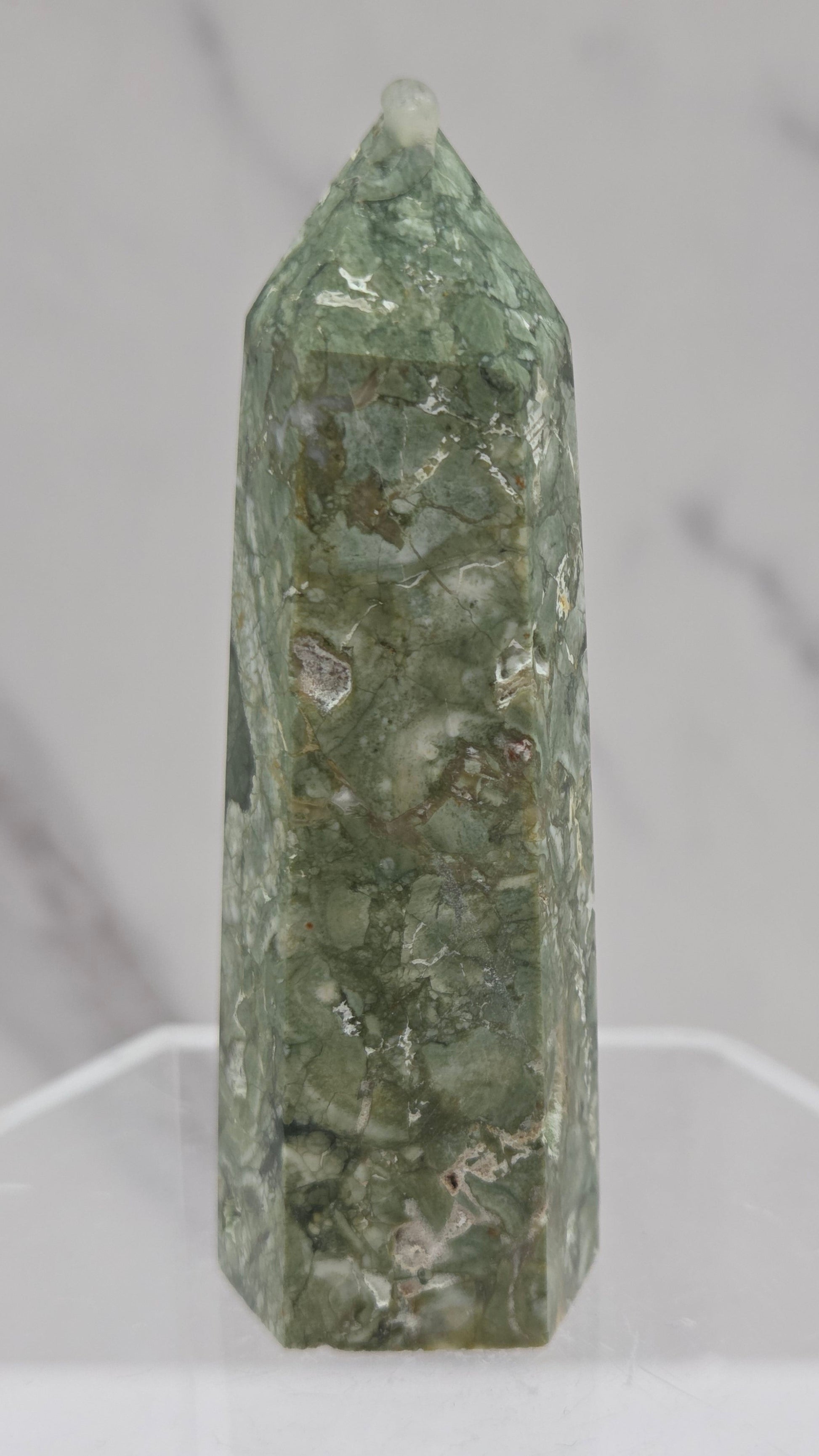 Decorative rainforest jasper tower with multiple colors and patterns on a white background