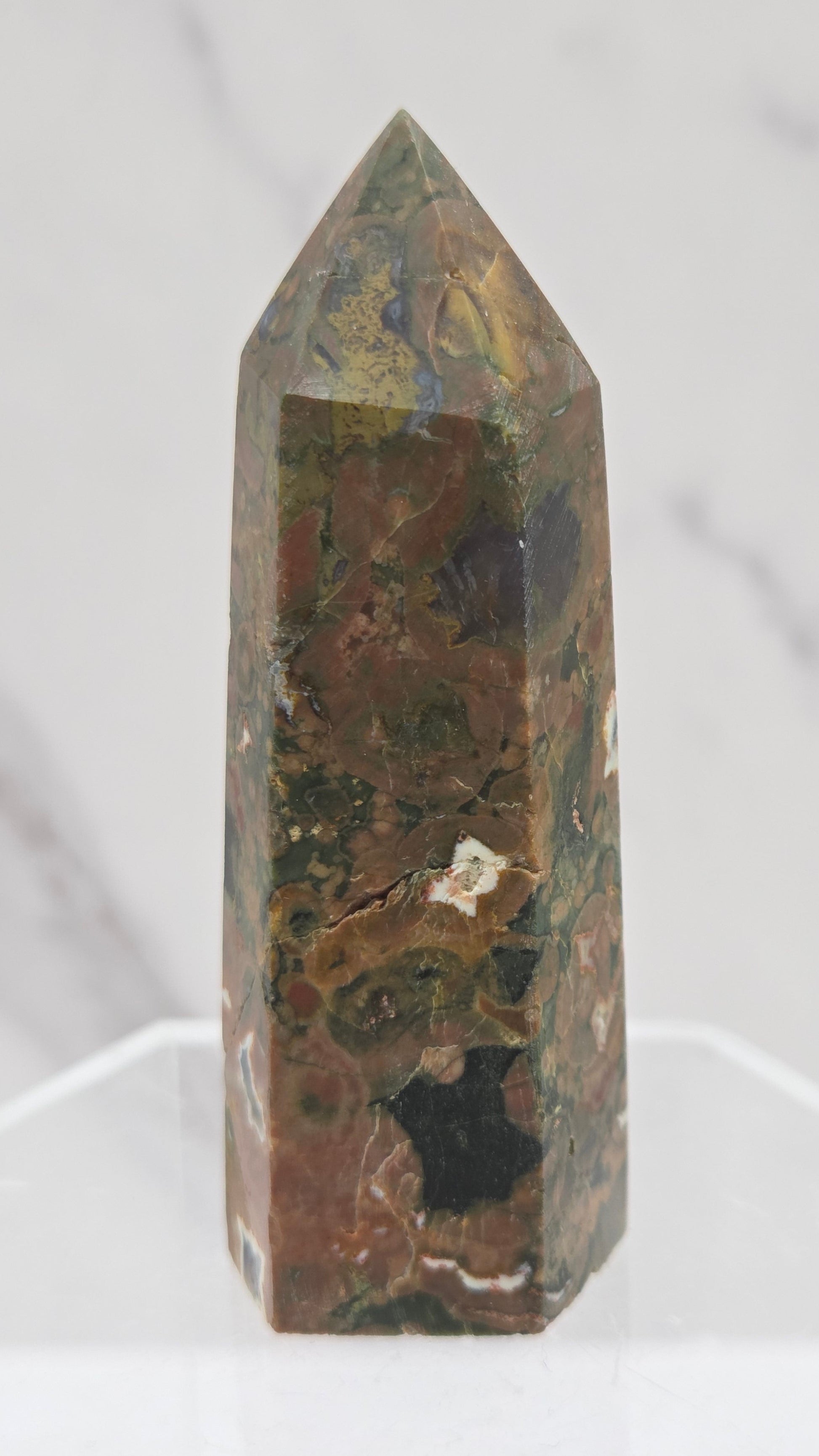 Decorative rainforest jasper tower with multiple colors and patterns on a white background