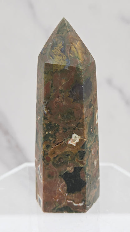 Decorative rainforest jasper tower with multiple colors and patterns on a white background