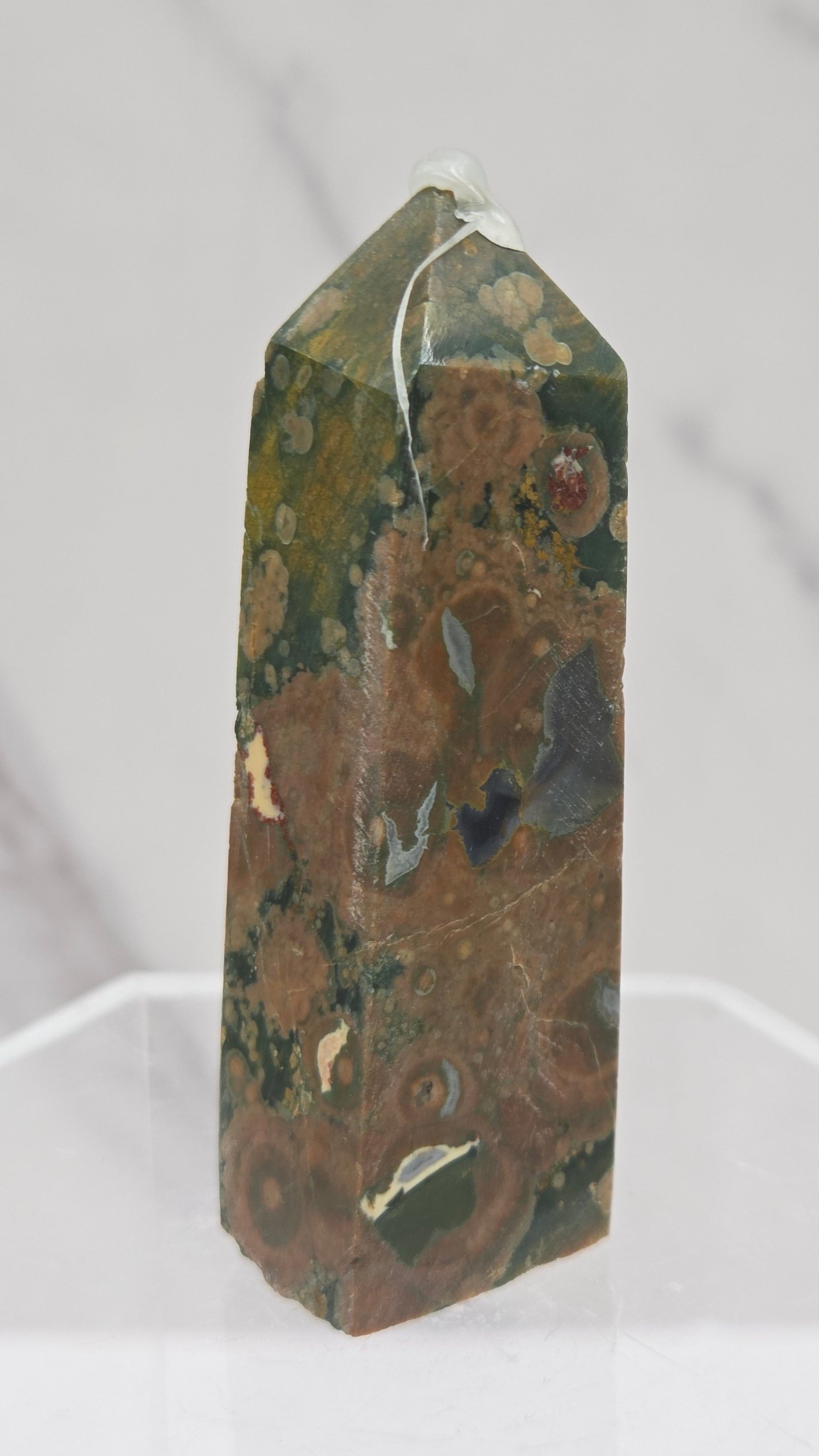 Decorative rainforest jasper tower with multiple colors and patterns on a white background