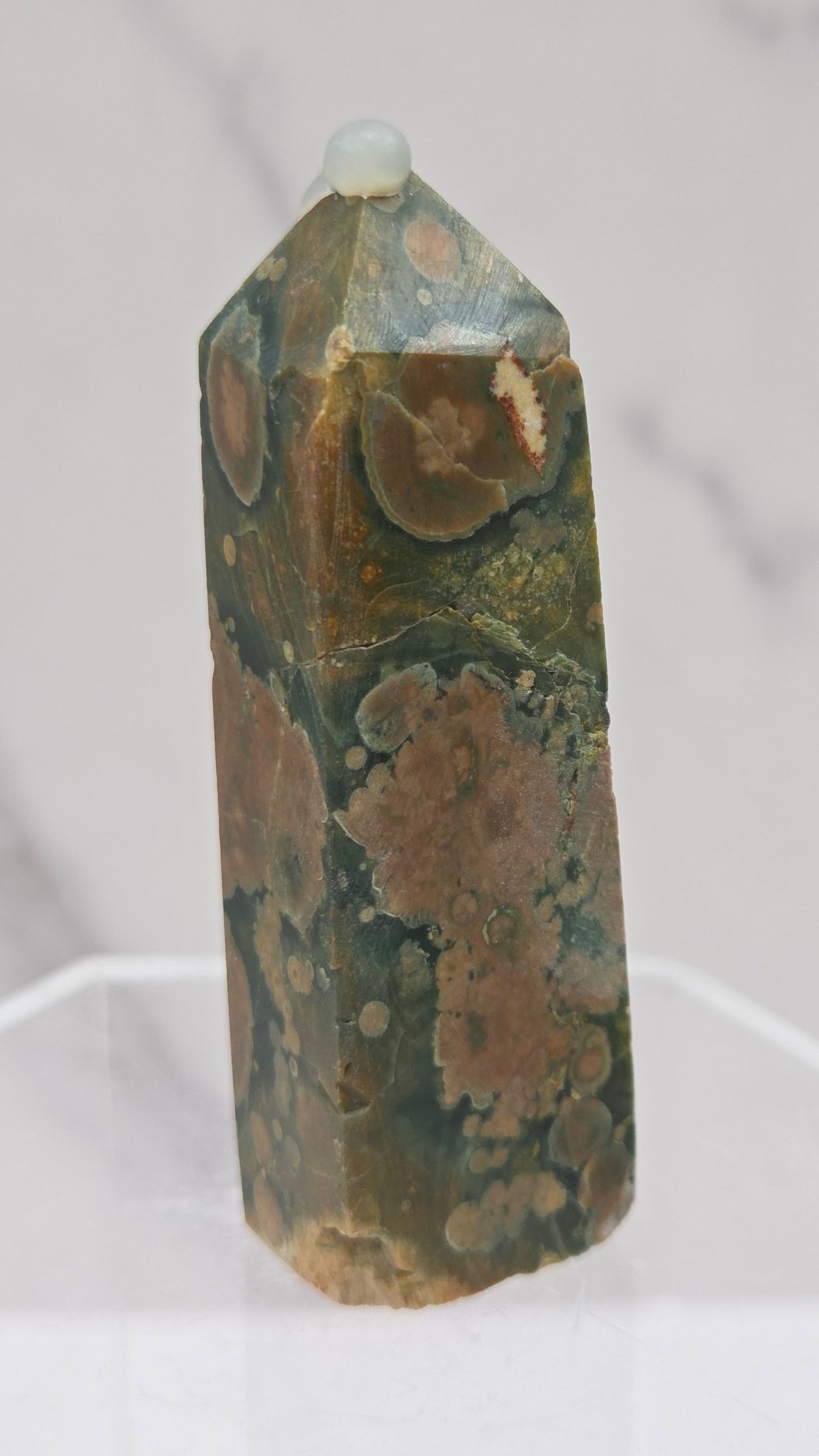Decorative rainforest jasper tower with multiple colors and patterns on a white background